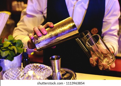 people are resting at a banquet. the barman pours drinks