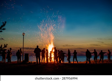 People Resting Near Big Bonfire Outdoor At Night