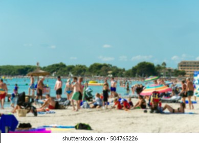 Lot of people resting on the summer beach. Blurred image.