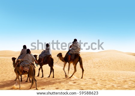 People ridding by camel