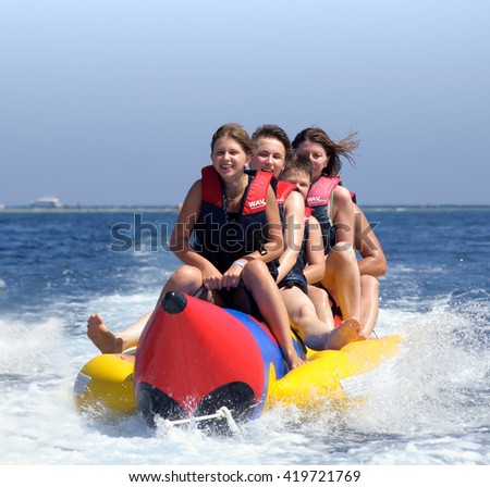 People ride on a banana boat.