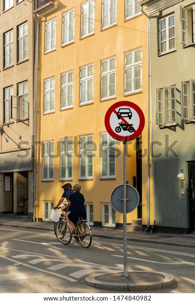 People riding bikes in Copenhagen, Denmark, sign\
no cars and motors\
Denmark