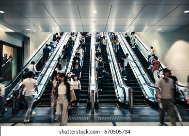 People Riding Escalators