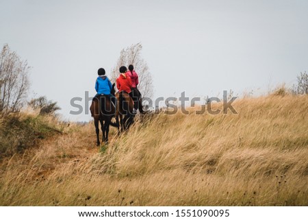 People riding horses in clay factory. Outdoor ridding with horses.