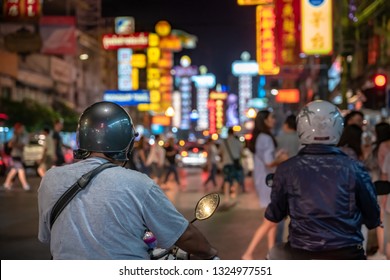 People Riding A Motorcycle Come To Yaowarat, Which Is The Chinatown Area Of Bangkok. The Commercial Area With Many People At Night And Street Food That Is Famous All Over The World