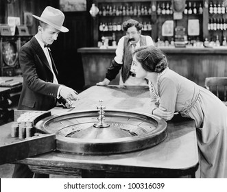 People At Roulette Table In Bar