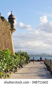 People Run Next To Castle In Puerto Rico