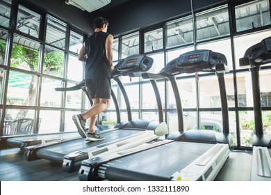 People Running In Machine Treadmill At Fitness Gym . Young Asian Man In Sportswear Running On Treadmill At Gym. Running Fast. 