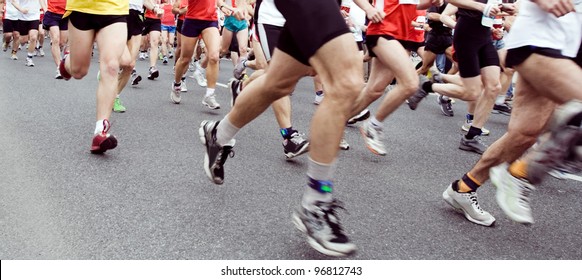 People Running Marathon On City Street, Sport And Fitness On The Urban Road. Runners On The Race, Only Legs And Shoes