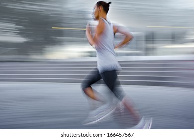 People Running On The City Street In Intentional Motion Blur