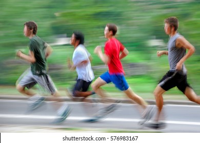 People Running On The City Street In Intentional Motion Blur