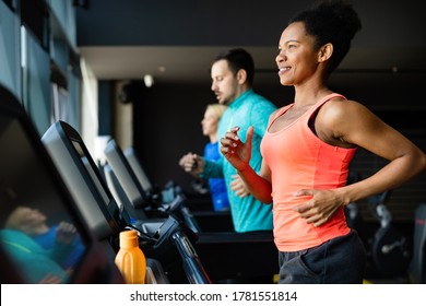 People running on treadmill in gym doing cardio workout - Powered by Shutterstock