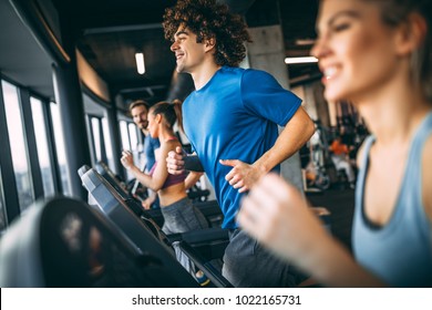 People Running On A Treadmill In Health Club