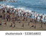 People running to take traditional cold bath at the North Sea on January, 1 at Scheveningen beach (the Hague, the Netherlands)