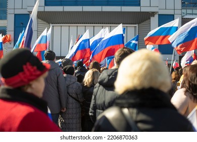 People With Russian Flags Are Walking Down Street. Russian Citizens At Rally. Many People Support Policy Of State. National Flag Of Russian Federation.