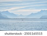 People sailing boat canoe on Lake Geneva. Sunny Lac Léman landscape. Lake Geneva. Sunny Swiss Vevey Mountain and Water Background View.