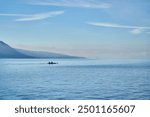 People sailing boat canoe on Lake Geneva. Sunny Lac Léman landscape. Lake Geneva. Sunny Swiss Vevey Mountain and Water Background View.