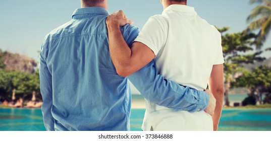 People, Same-sex Marriage, Honeymoon, Travel And Vacation Concept - Close Up Of Happy Male Gay Couple Or Friends Hugging From Back Over Exotic Resort Beach Background