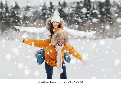 People, Season, Love And Leisure Concept - Happy Couple Having Fun Over Winter Background