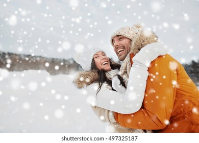 People, Season, Love And Leisure Concept - Happy Couple Hugging And Laughing Outdoors In Winter