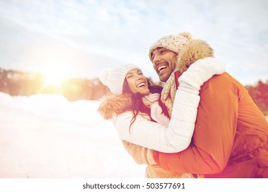 People, Season, Love And Leisure Concept - Happy Couple Hugging And Laughing Outdoors In Winter