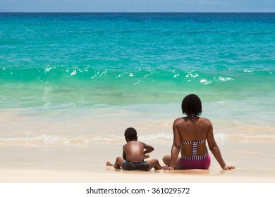 People Seated On The Sand In Front Of The Ocean At Santa Maria Beach In Sal Island, Cape Verde  - Cabo Verde