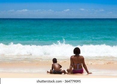 People Seated On The Sand In Front Of The Ocean At Santa Maria Beach In Sal Island, Cape Verde  - Cabo Verde