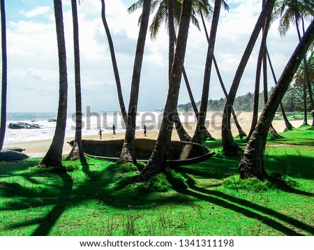 People seen from afar on beach in Liberia, Africa