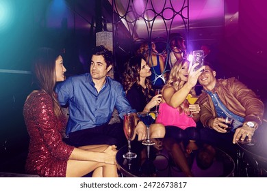 People, selfie or friends in nightclub with drinks, smile or cocktails for memory, vip event or reunion. Pictures, men or happy women on dark party couch for alcohol, photograph or social celebration - Powered by Shutterstock