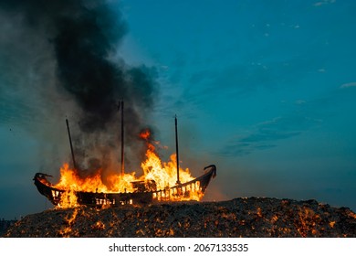 People set a huge wooden boat on fire, and believe that doing so can eliminate the bad luck in this area