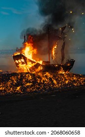 People set a huge wooden boat on fire, and believe that doing so can eliminate the bad luck in this area