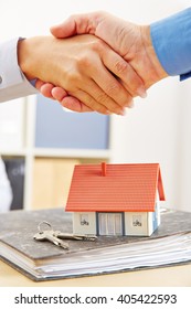 People Shake Hands Over Mortage Deal For Financing A House