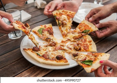 People Sharing A Pizza.