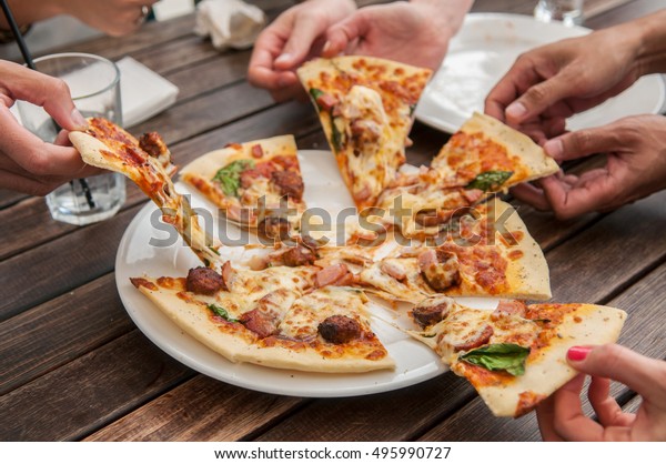 People Sharing Pizza Stock Photo Edit Now