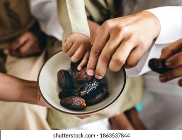 People sharing some dried dates