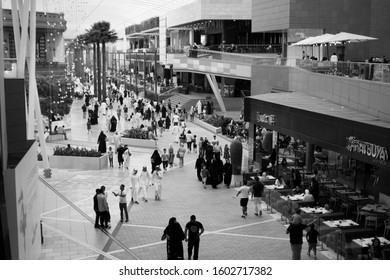 People Shopping In Avenues Mall In Kuwait. Ladies In Abaya And Men In Dishdasha Mixed With People In Western Attire. 