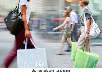 People Shopping In The City In Motion Blur