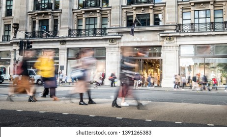 People Shopping On Busy Street In Motion Blur