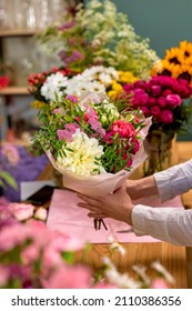 People, Shopping, Sale, Floristry And Consumerism Concept. Close-up Woman Hands Giving Flowers To Client At Flower Shop. Beautifully Made Prepared Bouquet On 8 March Or Another Holiday