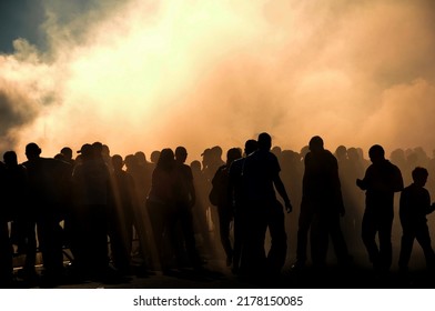 People silhouette with heavy smoke from burnt tyres on drift contest, concept of people on drift car event