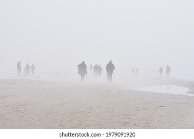 People Silhouettes In The Fog On The Beach. Walking In Pairs. Couples Walking In The Fog On The Beach. Nordic Walking. Spring Fog.