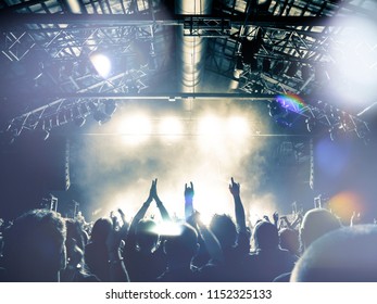 People Silhouettes In Front Of A Large Venue Concert Stage