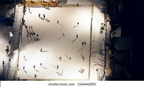 People Silhouettes Moving On  Ice Skating Rink, Aerial Top View