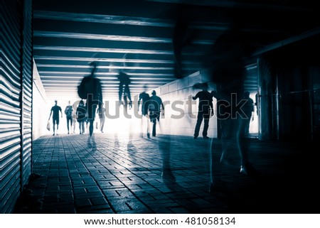 People silhouettes in the pedestrian tunnel.