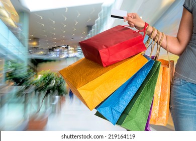 People Silhouettes At Shopping Mall In Motion Blur. Intentional Zoom Effect