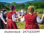 People singing and dancing dressed in traditional clothing. Annual Rose picking ritual in Bulgaria