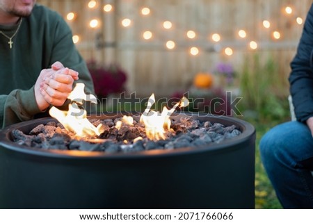 People sitting around an outdoor fire