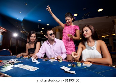 People Sitting In A Casino, Playing Poker, Man With Glasses Winning