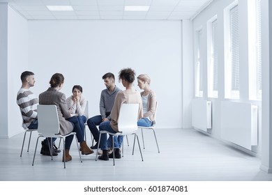 People Sitting In Circle During AA Group Meeting