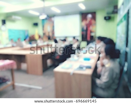 People sitting in meeting room, blurred image, black and white picture